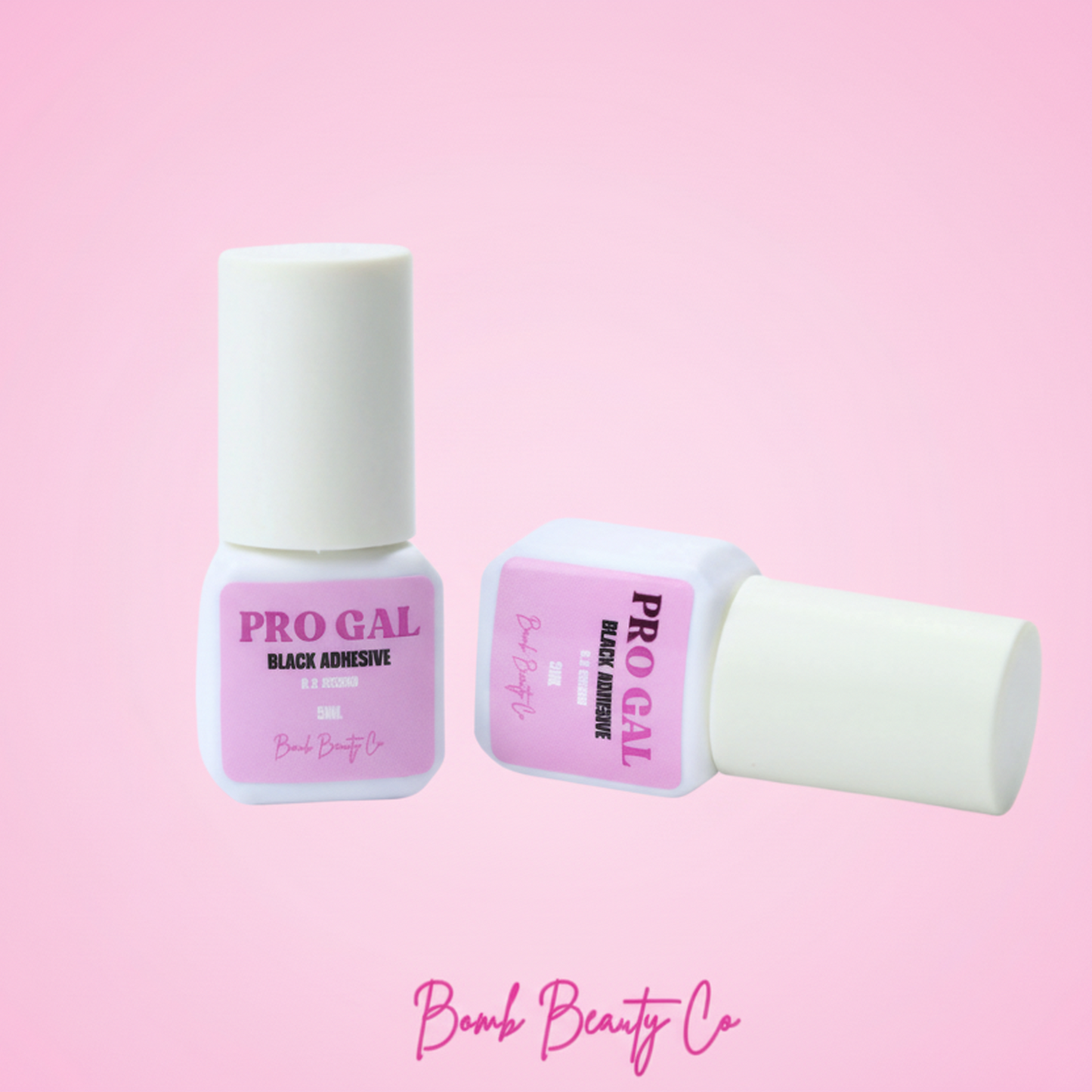 Two bottles of Pro Gal adhesive for false eyelashes, one cap off, on a pink background, with the Bomb Beauty Co. logo at the bottom.